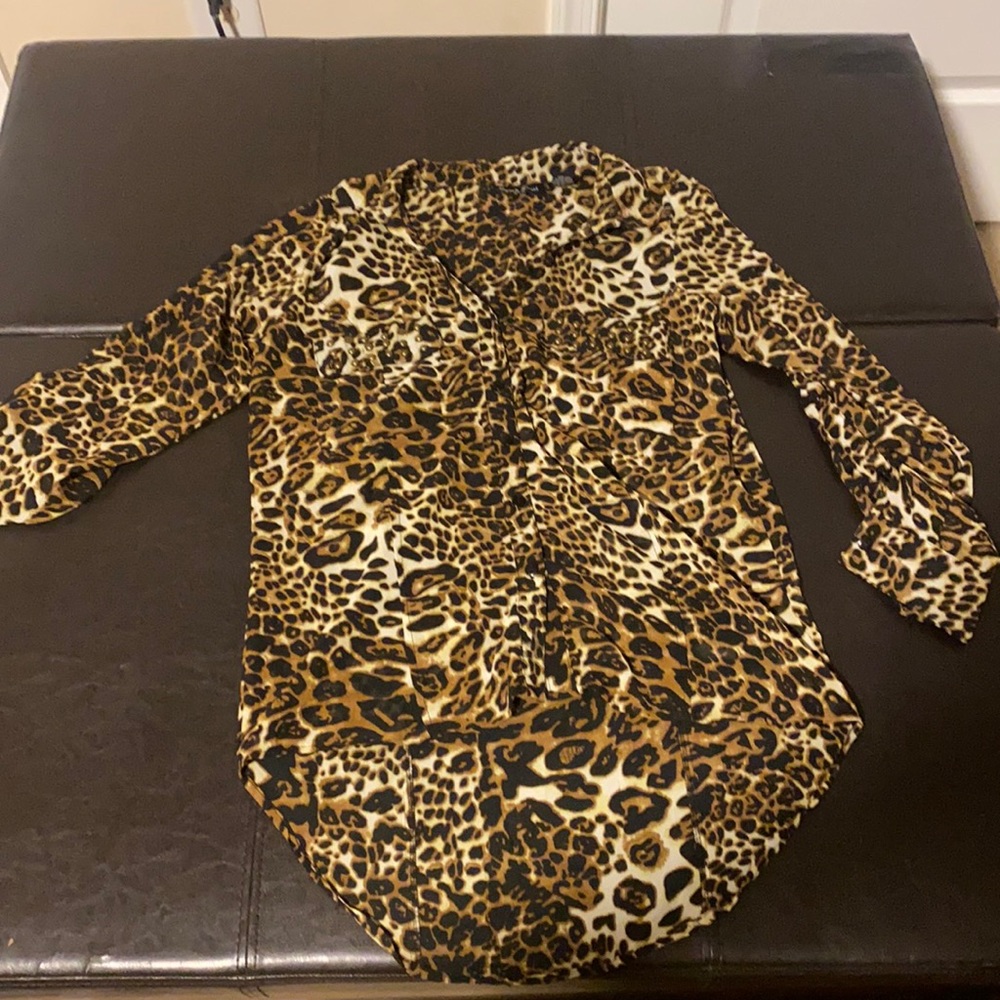 Cheetah print chiffon long sleeve blouse. Button details on sleeve
